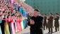 Kim Jong-Un applauds the participants in the second