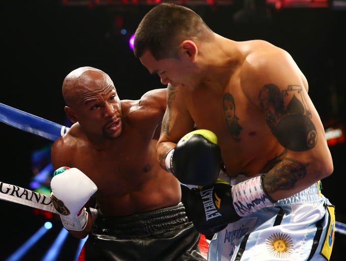 Floyd Mayweather Jr. punches Marcos Maidana during their fight at MGM Grand.