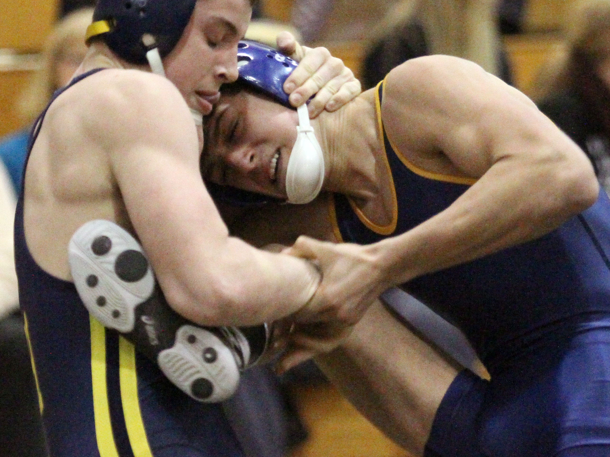 Hartland’s Nick DiNoble, left, beat Clarkston’s Jake Calvano by an 8-2 decision at 140 pounds in Wednesday’s regional semifinals.