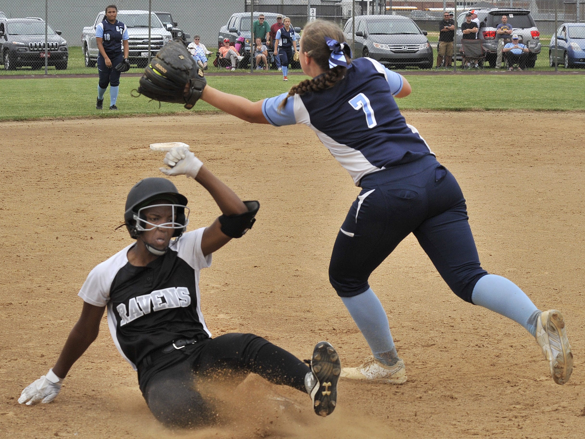Sussex Tech's Jakayla Sample slides into third with an RBI single that went all the way to the fence and give her team an insurance run in the bottom of the third inning. Spartans' third baseman Brooke Glanden takes the late throw from the outfield.