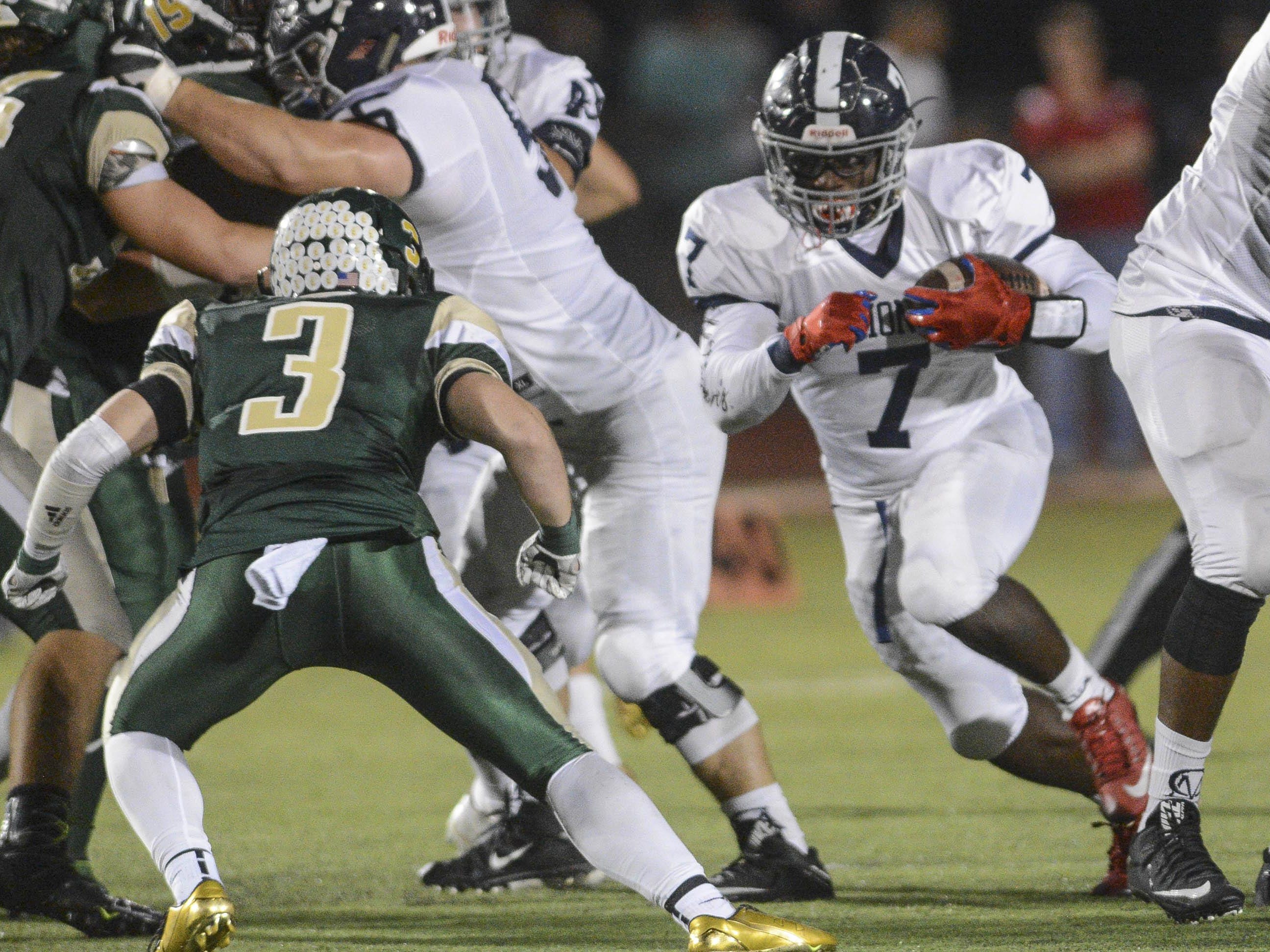 Keondre White (7) of Chaminade-Madonna runs through a hole in the MCC defense during Friday's Class 3A semifinal.