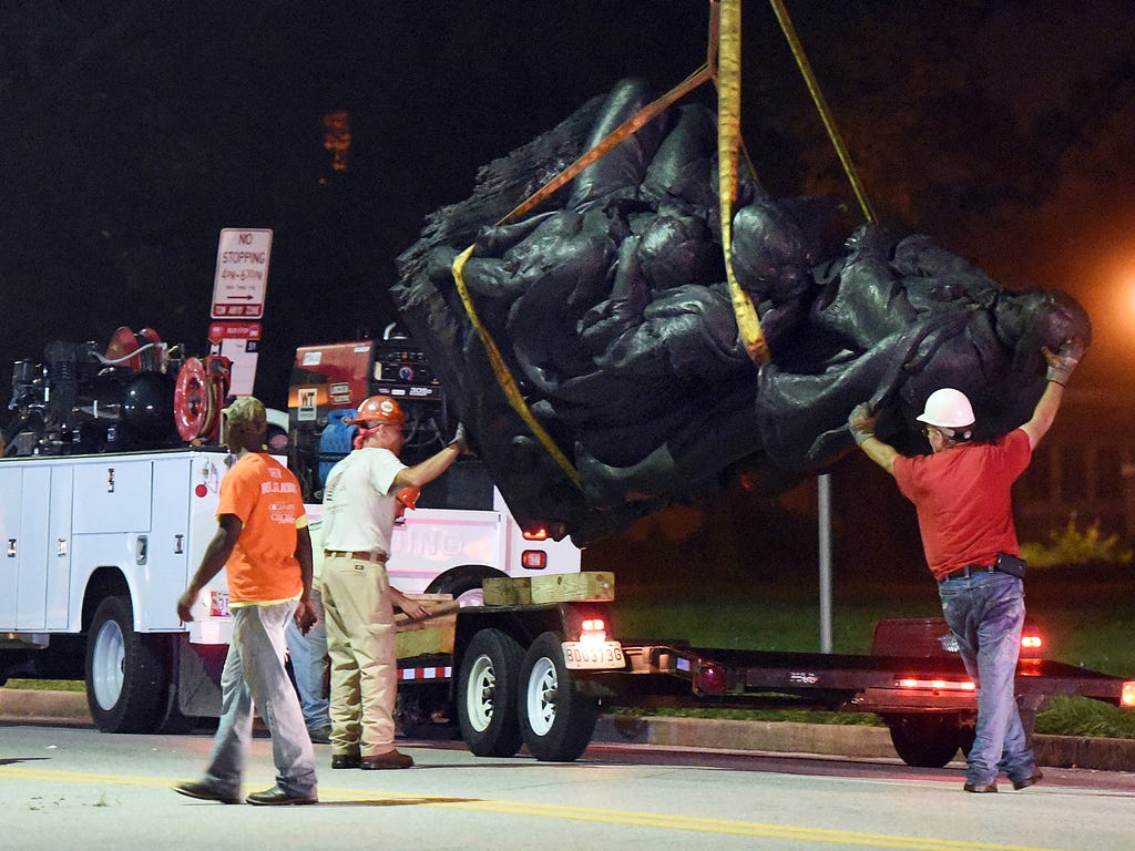 Workers remove a monument dedicated to the Confederate Women of Maryland early Aug. 16, 2017, after it was taken down in Baltimore. Local news outlets reported that workers hauled several monuments away, days after a white nationalist rally in Virgin