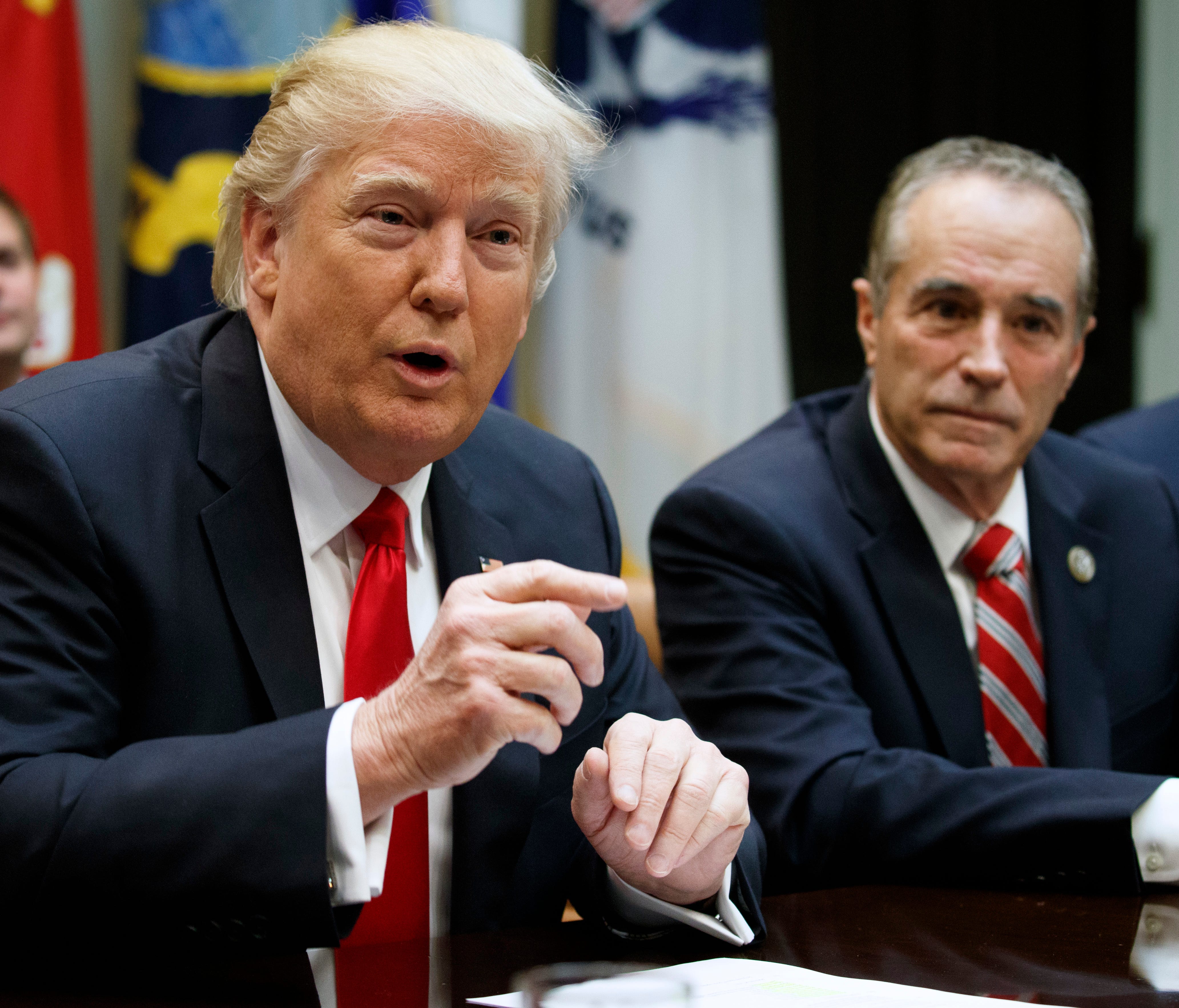 Rep. Chris Collins, R-N.Y., listens at right as President Trump speaks during a meeting with members of Congress in the Roosevelt Room of the White House on Feb. 16, 2017.