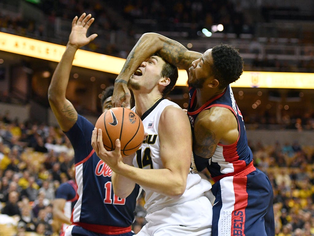 Missouri Tigers forward Reed Nikko shoots and is fouled by Mississippi Rebels guard Markel Crawford, right, during the first half at Mizzou Arena in Columbia, Mo.