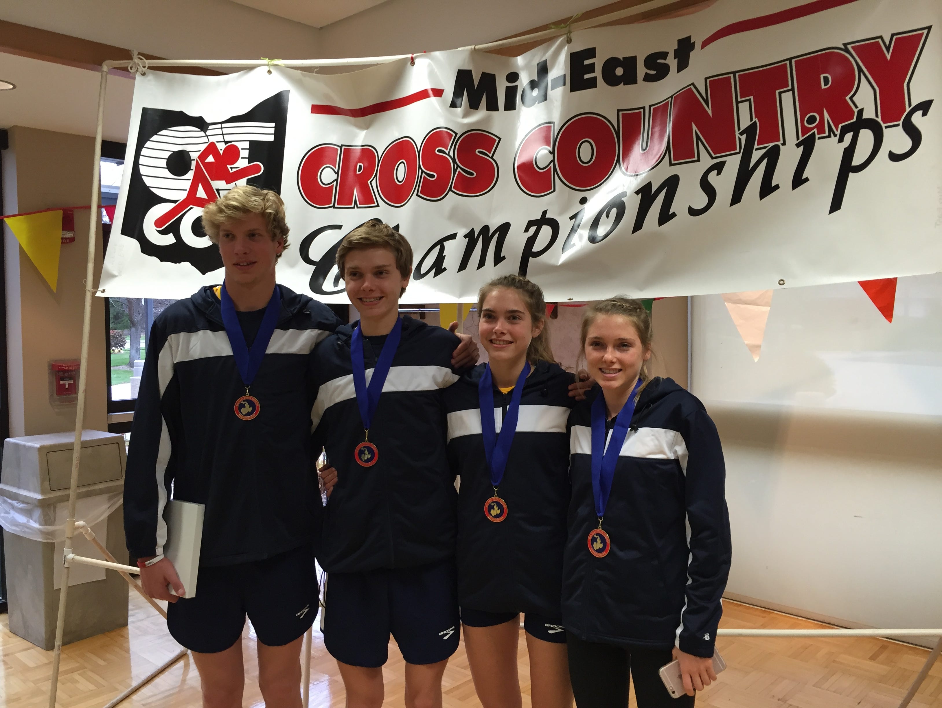 Cooper Williams, from left, Evan Johnson, Kristen Johnson and Lauren Johnson represented West Lafayette at the Mid-East Cross Country Championships on Saturday in Kettering, Ohio.