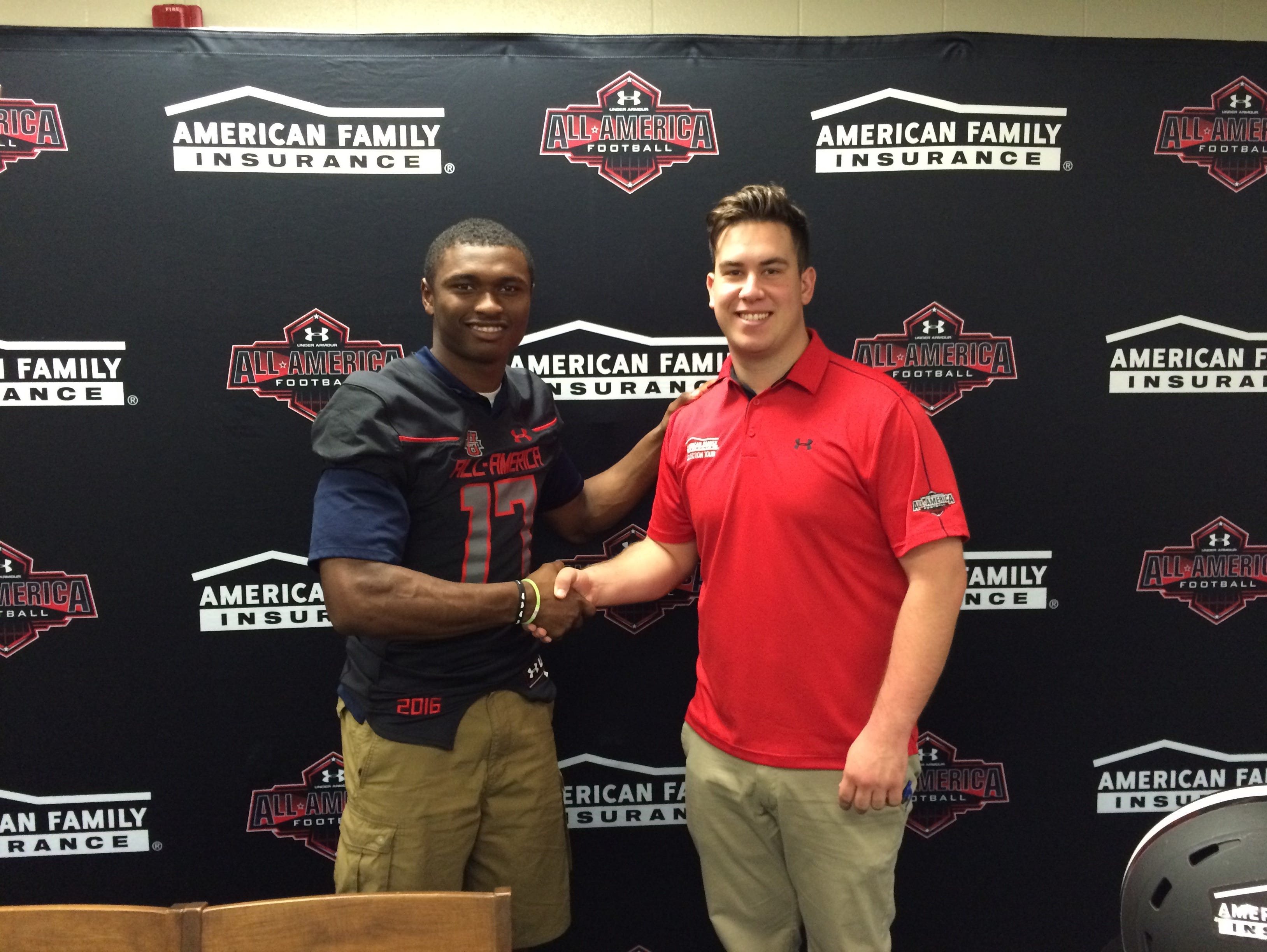 Oakland's JaCoby Stevens, left, accepts a jersey from Under Armour All-American Game's Corey Gibson.