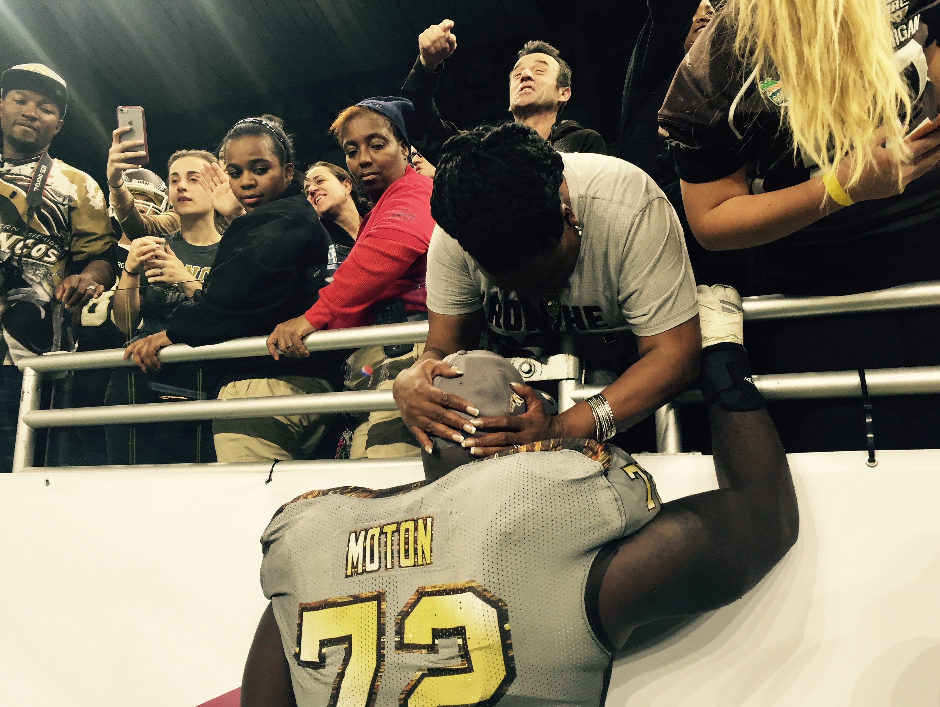 Senior Taylor Moton embraces his mother Sonya Gunnings-Husband after his Western Michigan Broncos knocked off Ohio 29-23 in the MAC Championship at Ford Field in Detroit on Dec. 2