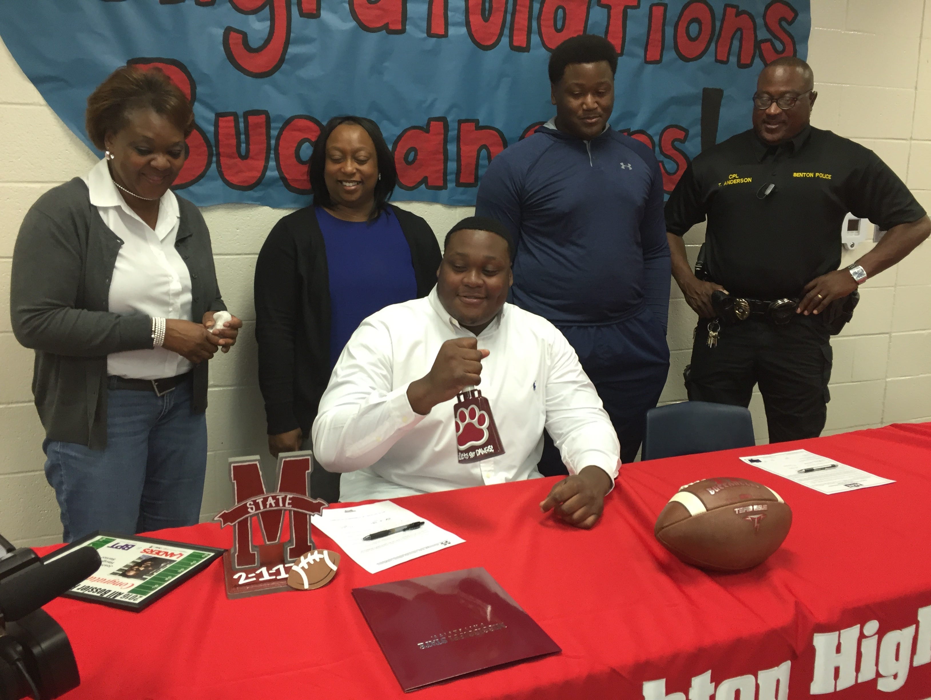 Surrounded by his family, Haughton's Josh Cooper rings a cowbell after signing with Mississippi State.