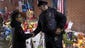 A boy shakes hands with an NYPD police officer at a