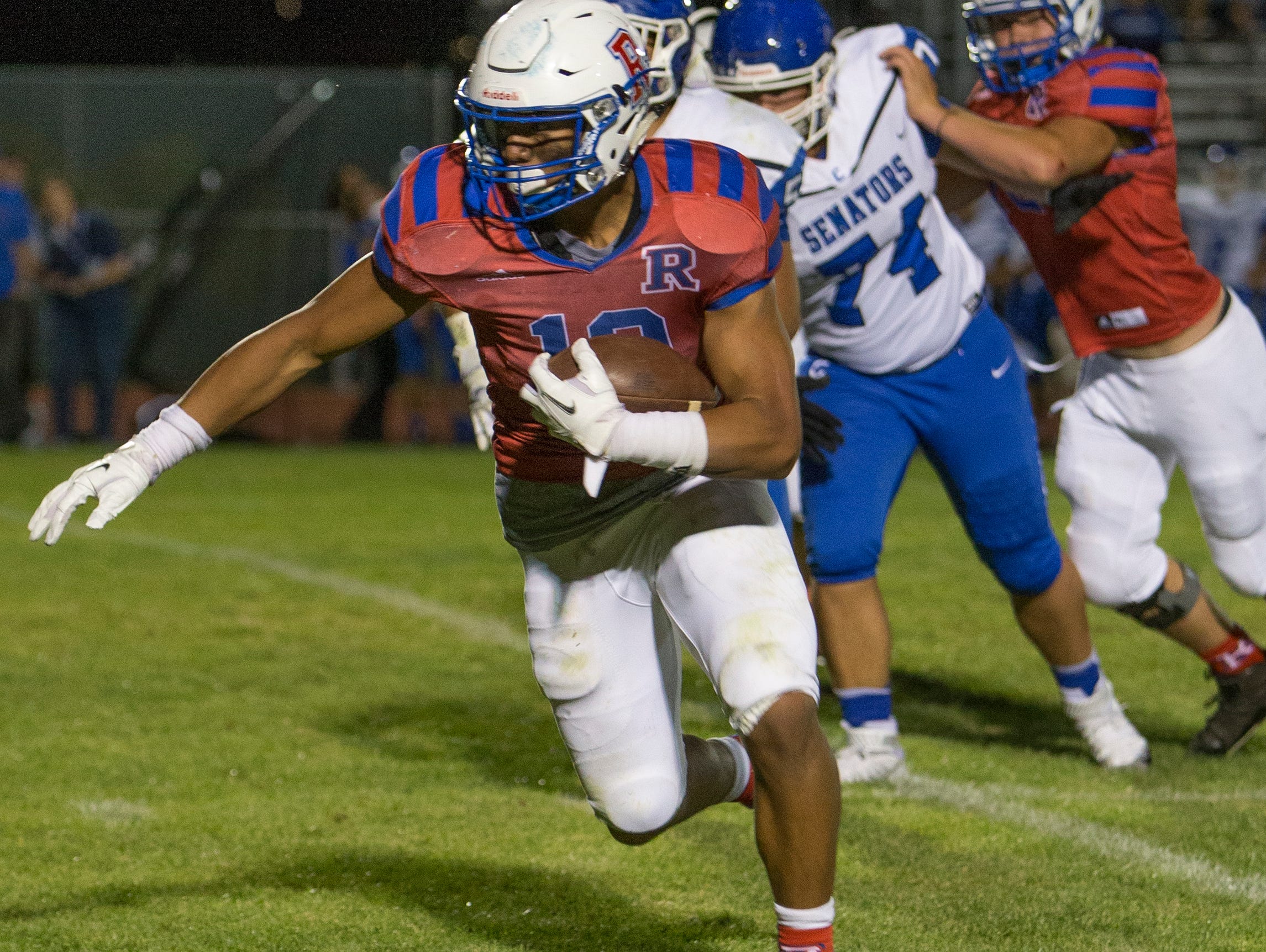 Reno's Brandon Kaho runs for a touchdown in the second quarter against Carson in their football game at Reno High School on Friday night, Sept. 2, 2016.