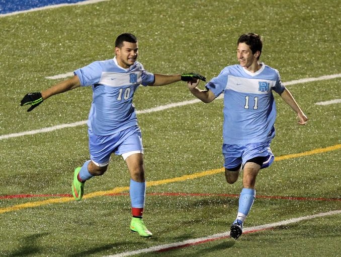 From left, Rye Neck's Luis Galeano (10) celebrates his second goal of the game against Highland with teammate Pierre Klur (11) during the boys soccer Class B regional semifinal at Middletown High School Nov. 5, 2014. Rye Neck won the game 2-0.