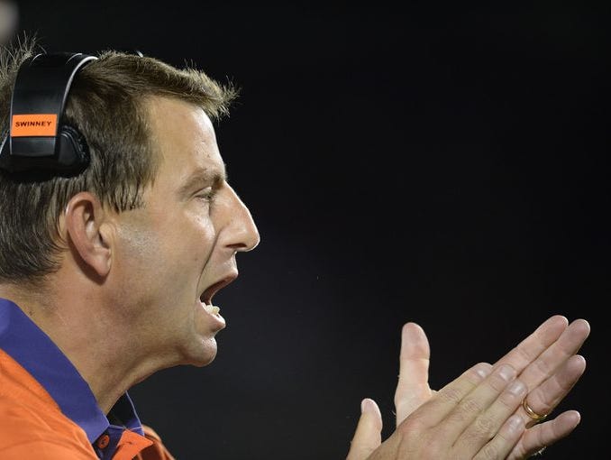 Clemson coach Dabo Swinney urges on his team during a 20-17 win at Louisville on Sept. 17.