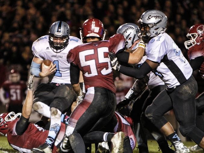 Lansing Catholic QB Tony Poljan (1) has decided to look around at schools.