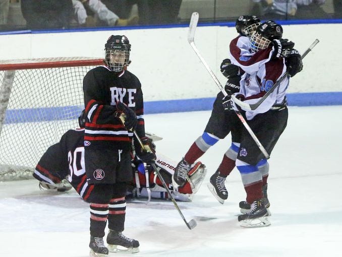 Rye Town/Harrison's Sam Adler, right, scored the first goal of the game as Rye and Rye Town/Harrison battled in a Division II playoff game at the Playland Ice Casino Feb. 23, 2015.