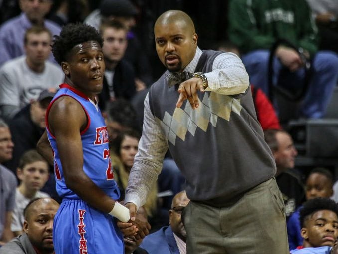 Lansing Everett's head coach Desmond Ferguson talks with Victor Edwards, during the MHSAA boys basketball Class A semifinals against North Farmington at the Breslin Center in East Lansing, Mich. on Friday.