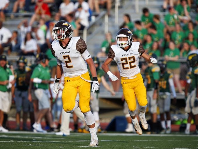 From left, Kickapoo football players Travis Vokolek (2) and Cole McCarville (22) celebrate a defensive stop at Parkview's JFK Stadium on Friday, Aug. 16, 2016. Kickapoo beat Parkview 55-26.