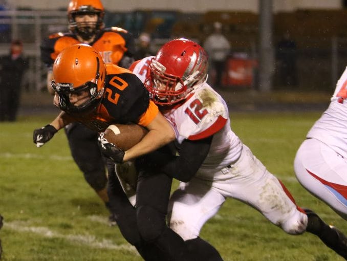 Glendale middle linebacker Kyle Doran (12) tackles Republic's David Feil (20) during a 2015 district playoff game at Republic.