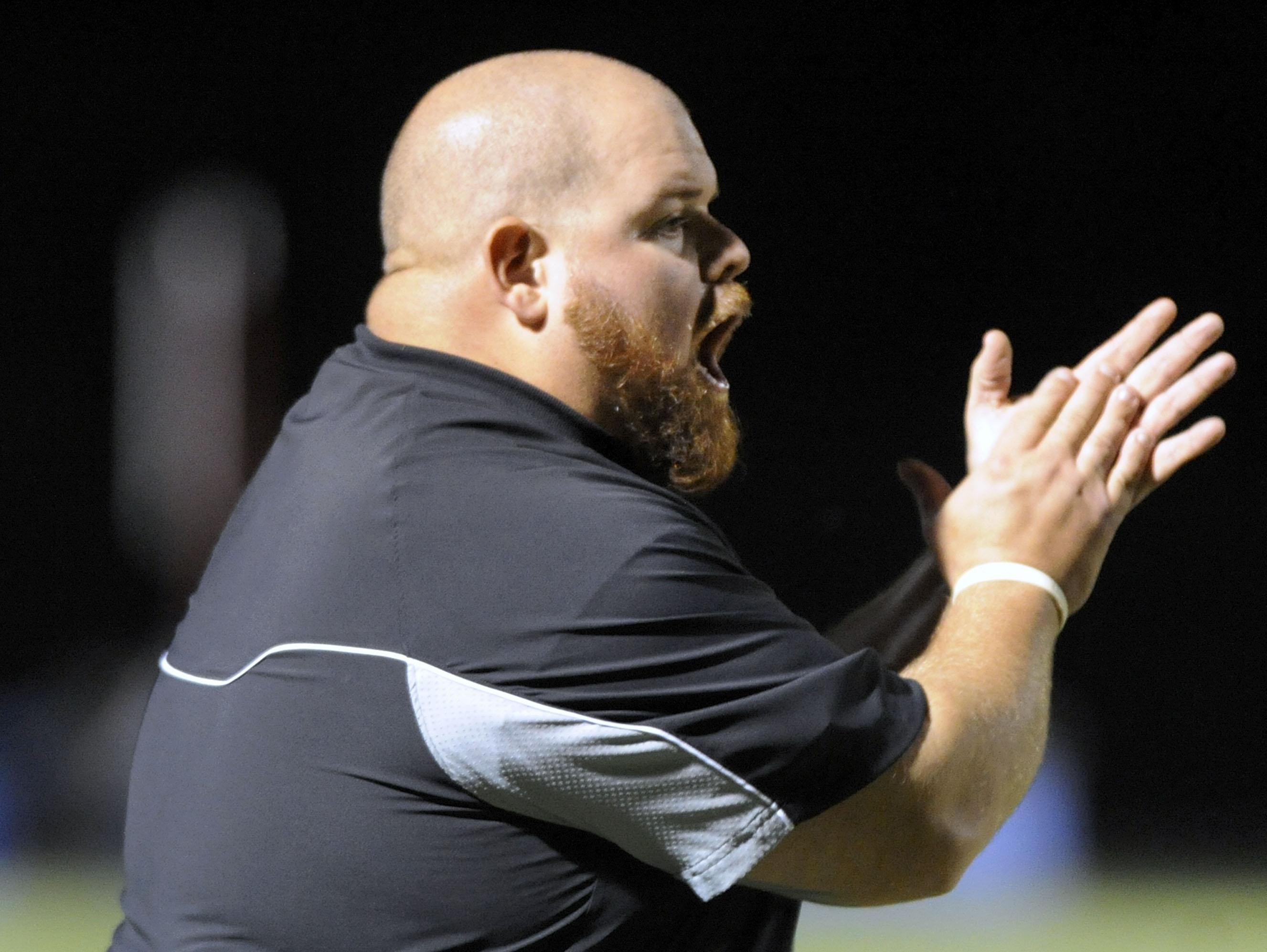 Parkside head coach Brendan Riley coaches his team against Kent Island in the first half of a high school football game at Kent Island High School in Stevensville Friday, Oct. 3, 2014.
