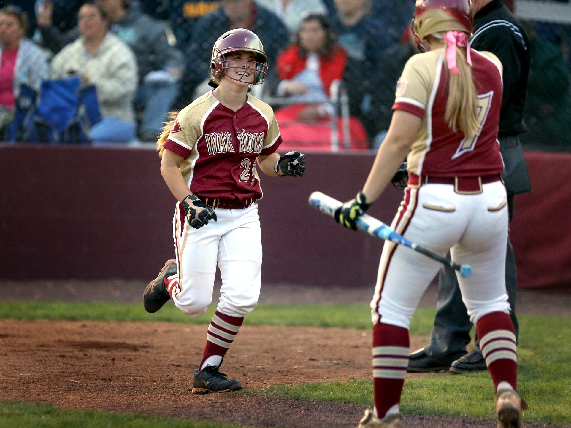 Riverdale's Brooke McClure is all smiles as she returns to the dugout after scoring on a throwing error in the third inning during the Lady Warriors’ 5-3 win over Siegel on Thursday. The loss was Siegel’s first in District 7-AAA play.