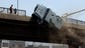 A police vehicle is pushed off of the 6th of October Bridge by supporters of ousted president Mohammed Morsi.