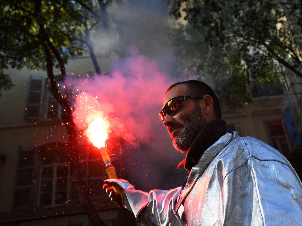 A protester holds a flair as he takes part in a demonstration as part of a nationwide protest day against the government's economic and social reformsin Marseille, southeastern France.