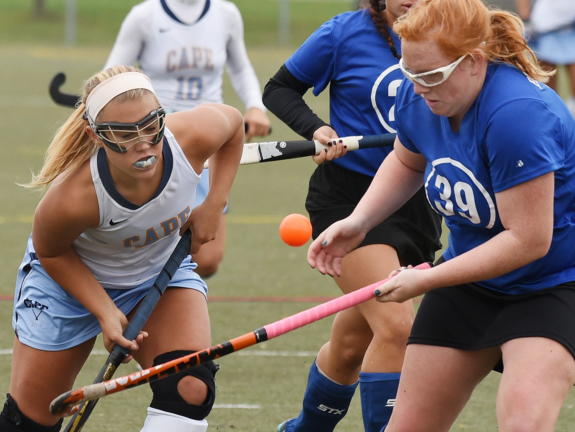 Brandywine's Laurel Bradley and Cape's Sydney Ostroski fight for the ball as Cape Henlopen High School (white) hosted Brandywine HS (blue) in the 1st round of the Delaware State HS Hockey Tournament at the school near Lewes on Wednesday November 11.