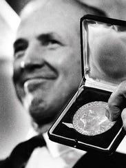 Norman Borlaug displays his Nobel Peace Prize in Cresco