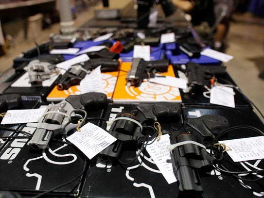 Handguns are seen at a gun show hosted by Florida Gun
