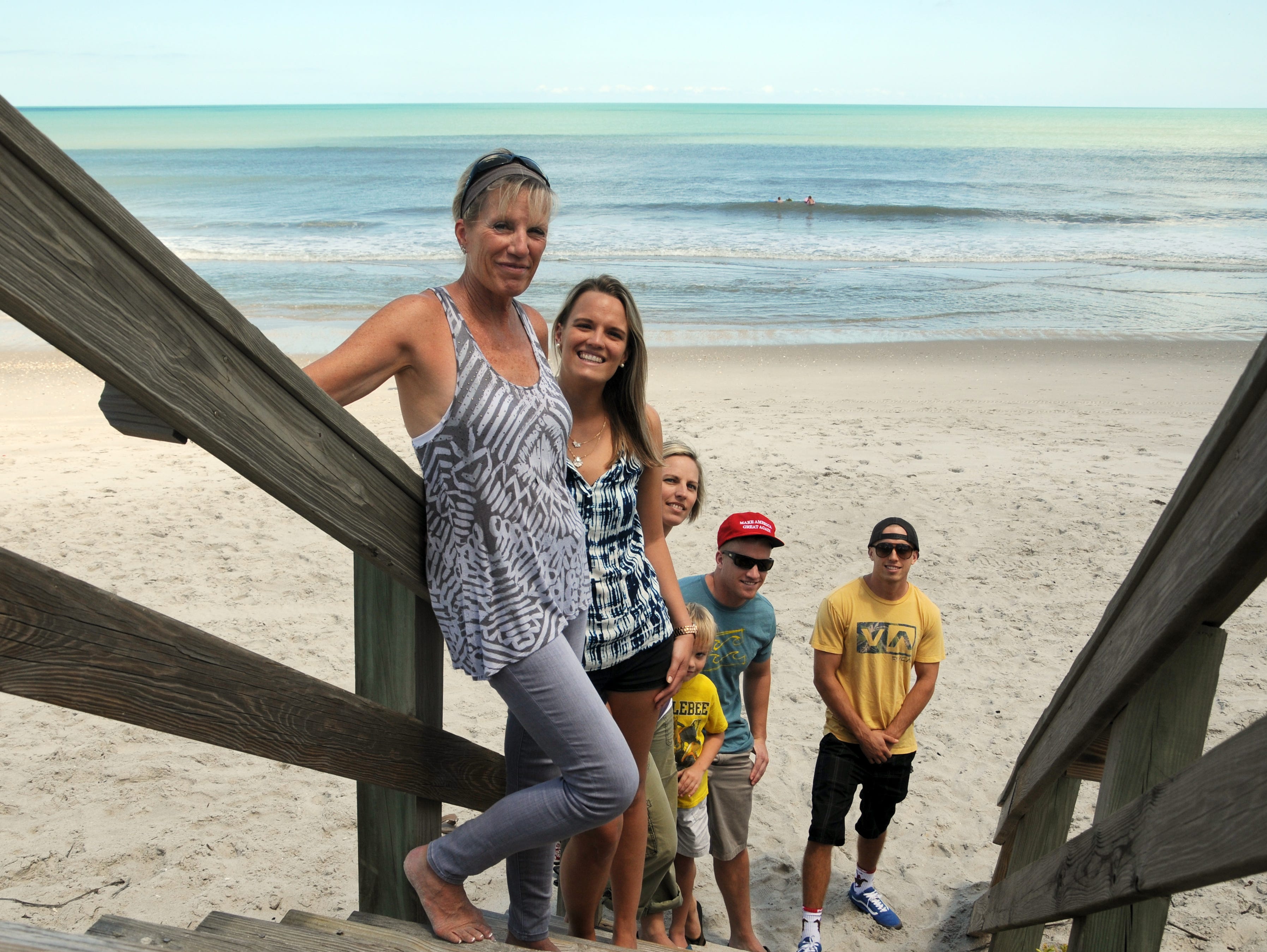 Linda Anderson and her children: daughters Madison Smith and Tiffany Brown, grandson Bodhi Brown, sons Mason Smith, and Calvin Smith walk the beach in Satellite Beach Saturday afternoon.