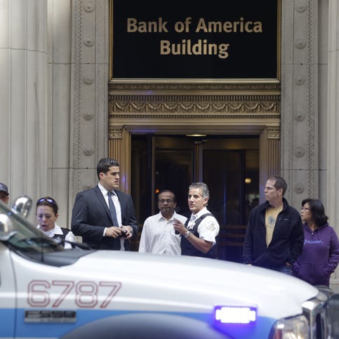 Police stand outside a downtown high-rise office building following a shooting on July 31, 2014, in Chicago.