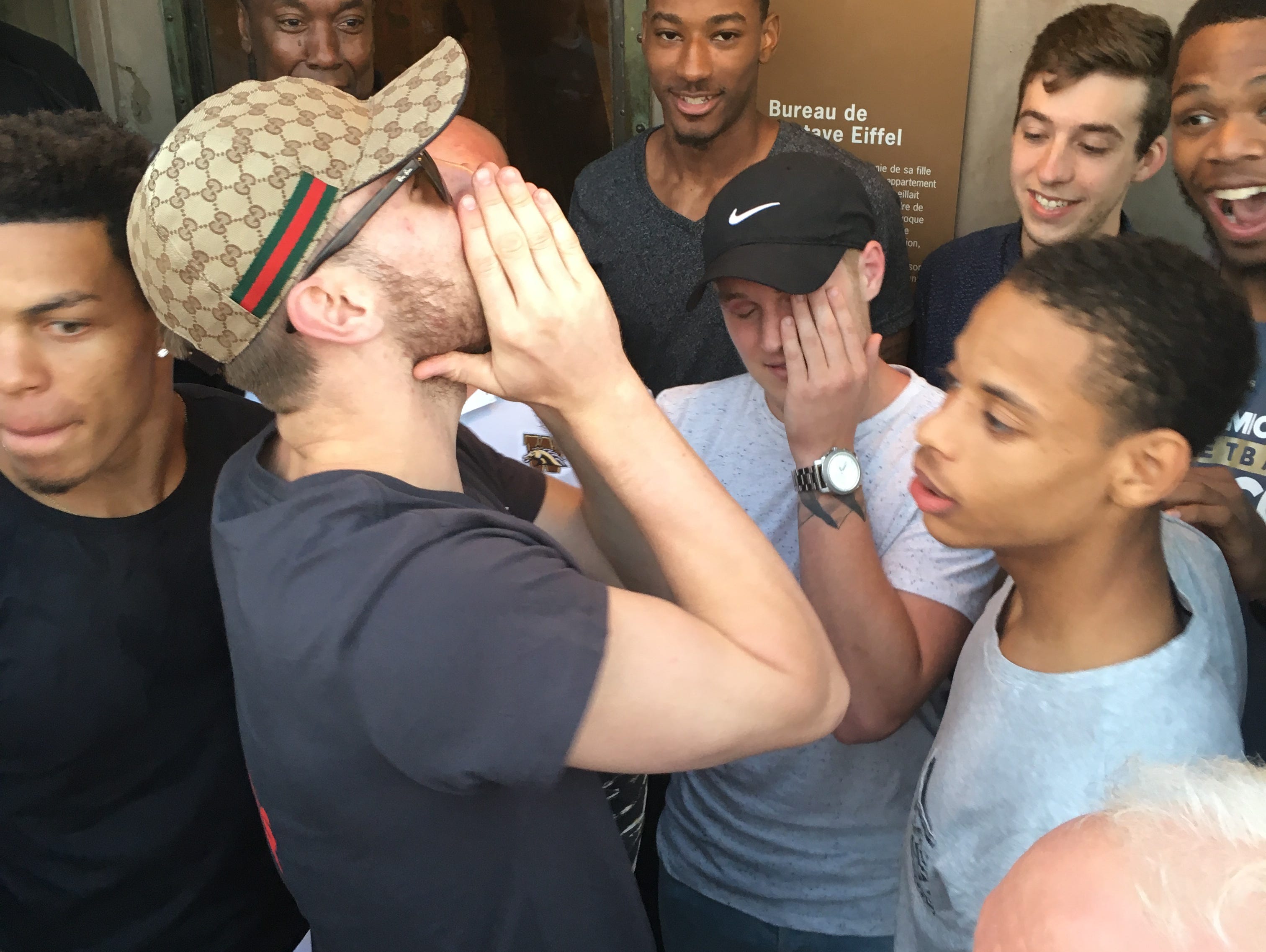 Western Michigan guard and Laingsburg grad Ryan Wade, center, is overcome by emotion after learning he received a full ride scholarship for the season on top of the Eiffel Tower earlier this week.