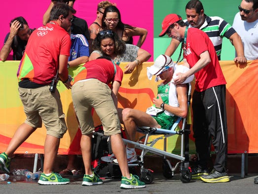 Sandor Racz of Hungary is helped after collapsing during