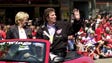 Marian and Mike Ilitch rode an open car  in the Red
