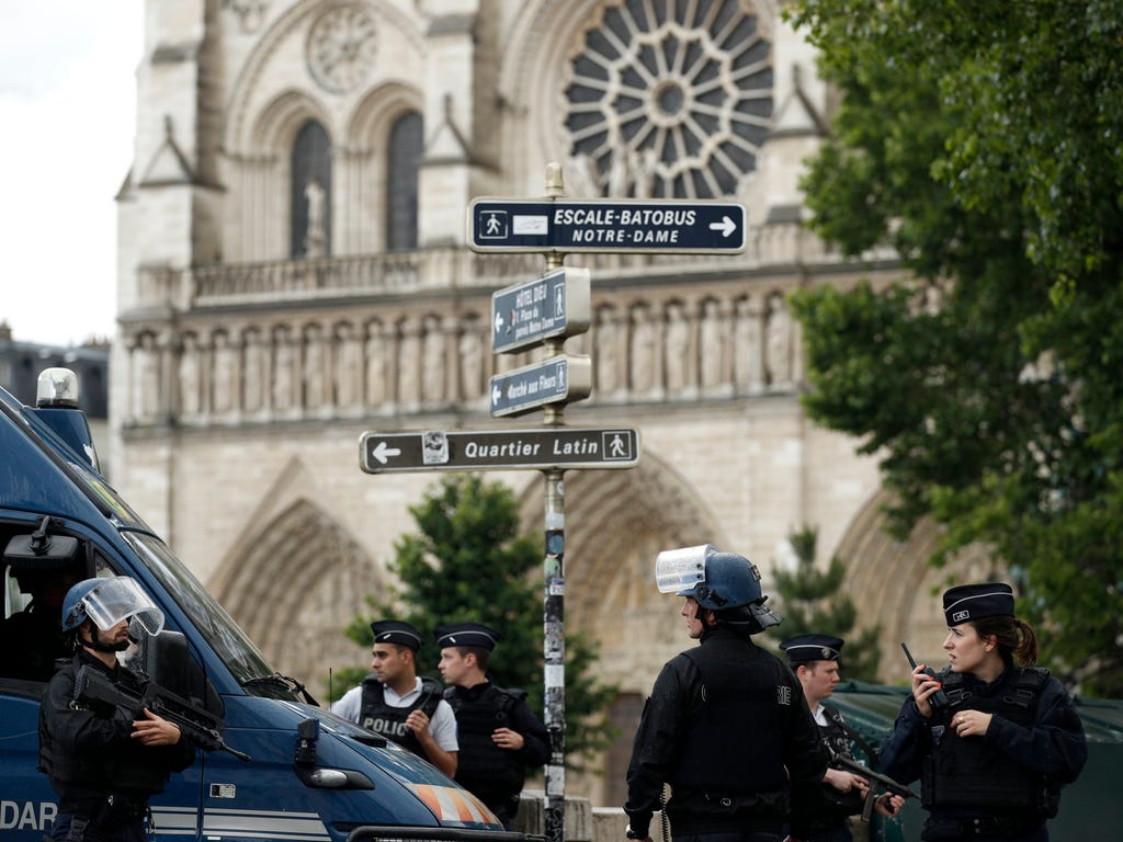 French police officers install a security parameter outside of the Notre Dame cathedral after a man attacked a police officer with a hammer, in Paris, France on June 6, 2017. It was reported that the assailant has been shot and injured by police.