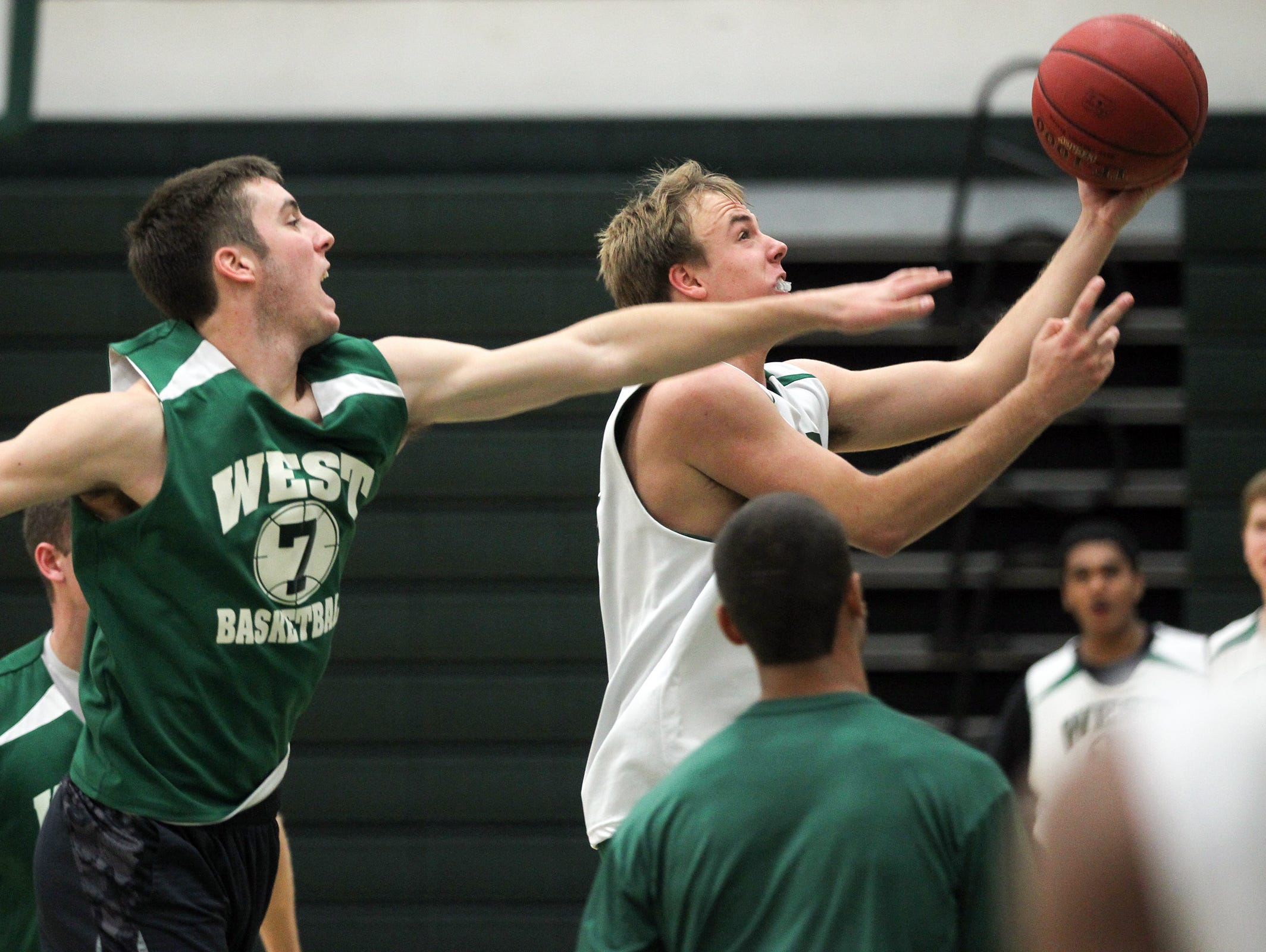 West High's Alex Henderson drives past Connor McCaffery during practice on Thursday, Nov. 19, 2015.