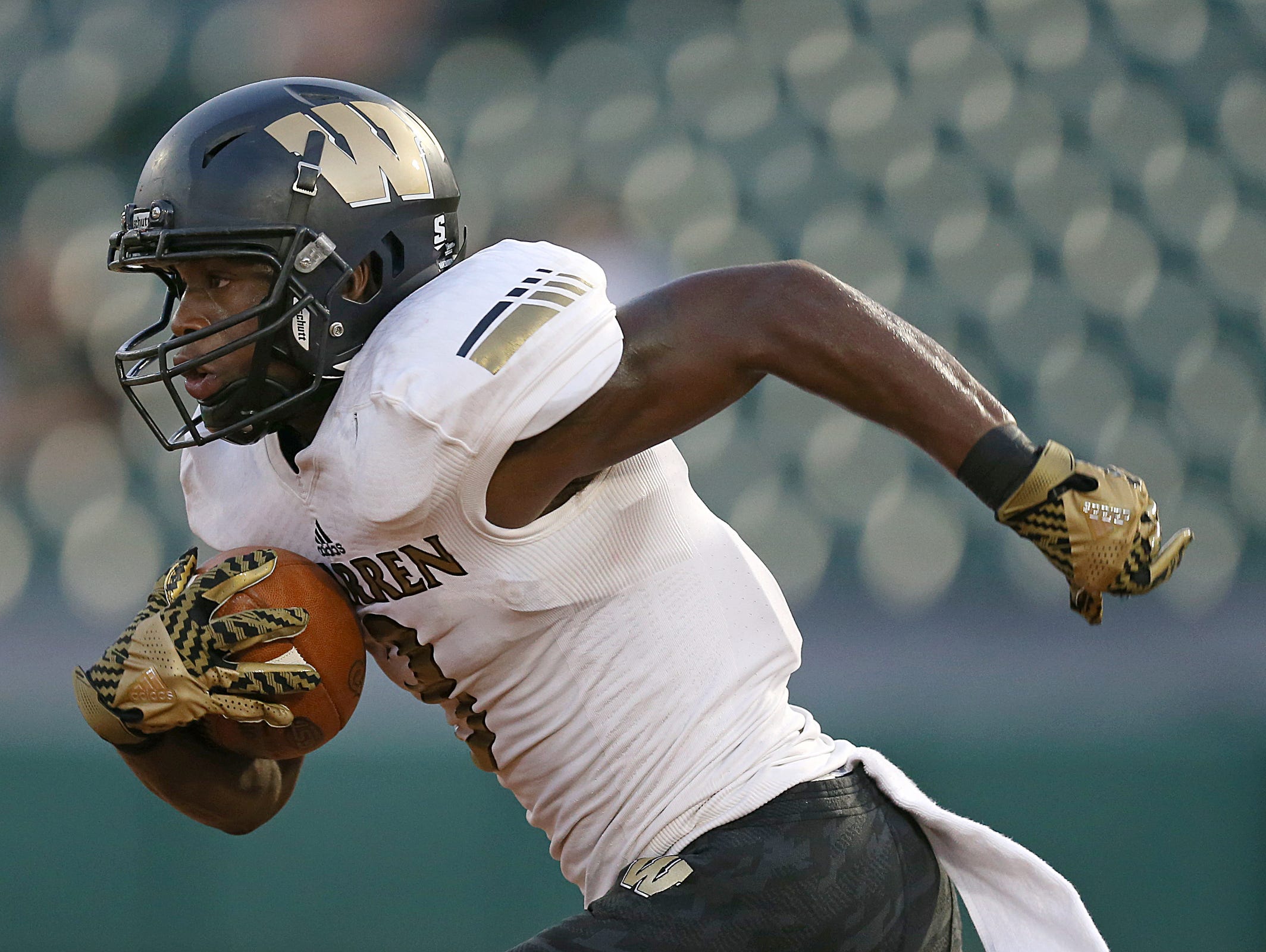 Warren Central Warriors Dijon Anderson (3) makes a long run down the field leading the Warriors to a touchdown on the next play, during first half action of the Gridiron Classic at Victory Field, Indianapolis, Friday, September 23, 2016.
