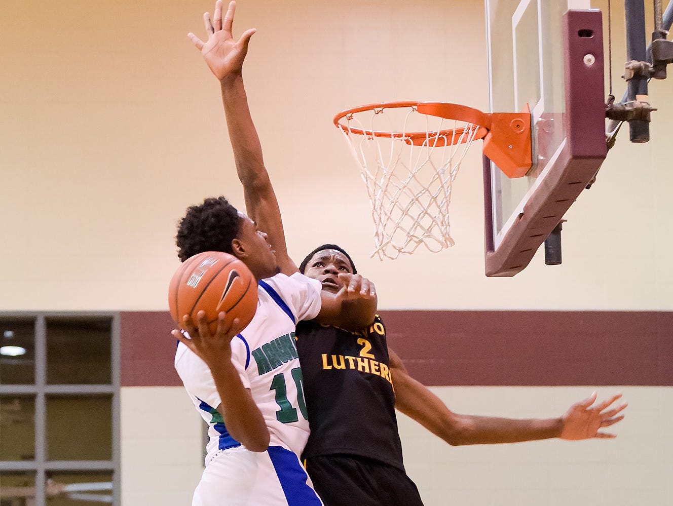 Lamar Hamrick (No. 10) of St. Georges Technical High School takes the ball to the net.