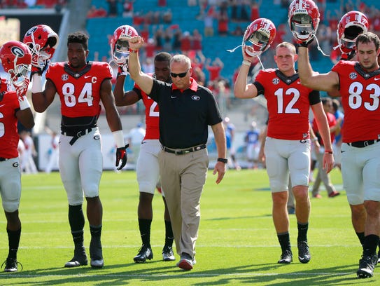 Richt and his players leave the field after falling