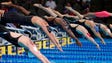 Swimmers leave the starting blocks during the women's