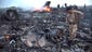 People inspect the debris after a Malaysia Airlines passenger jet with 295 people on board crashed near Grabovo, Ukraine, July 17. Ukrainian military officials say the Boeing 777 passenger plane carrying 295 people was shot down by a missile as it flew over rebel-held eastern Ukraine.