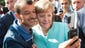 German Chancellor Angela Merkel  has a selfie taken