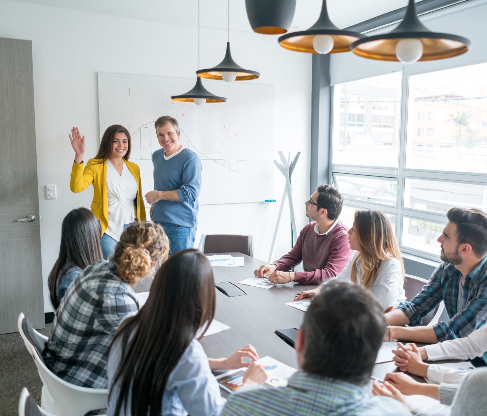 Group of people in a business meeting at the office introducing a new member of the team