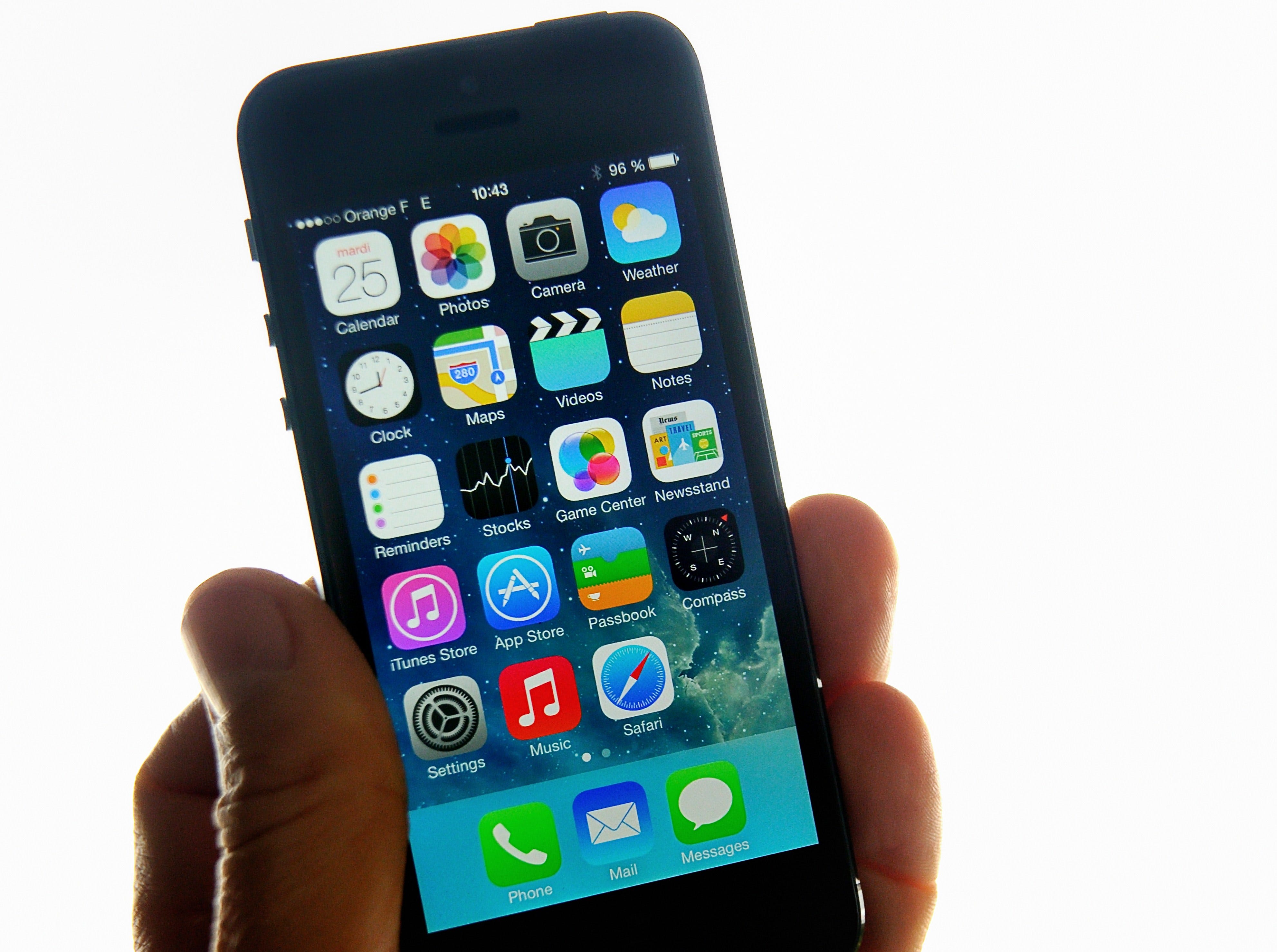 Millennials like using apps and their smartphone's camera to bank, shop and much more. A man displays Apple's iPhone 5 smartphone.