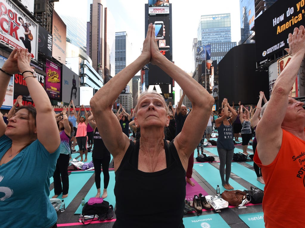 People take part in the 15th annual Times Square yoga event celebrating the Summer Solstice, the longest day of the year, during classes in the middle of Times Square in New York.\u000d\u000aThe event marked the international day of yoga.