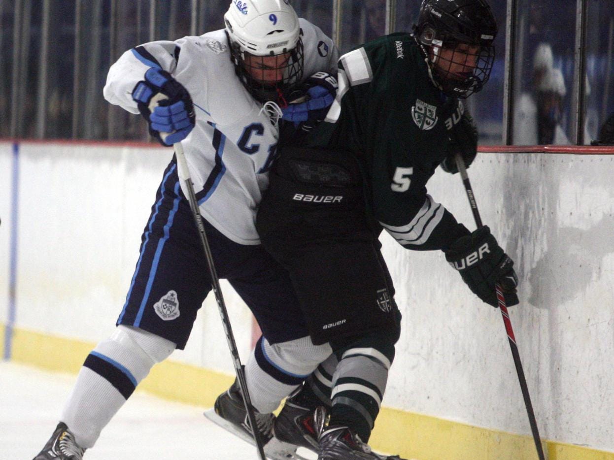 Billy Antonides, #9 CBA, checks Andrew Petrillo, #5 Delbarton, into the boards during an ice hockey game Wednesday, January 8, 2014, at Jersey Shore Arena in Wall Township. Jody Somers / For The Asbury Park Press