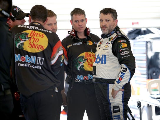 Tony Stewart talks to his crew following the first