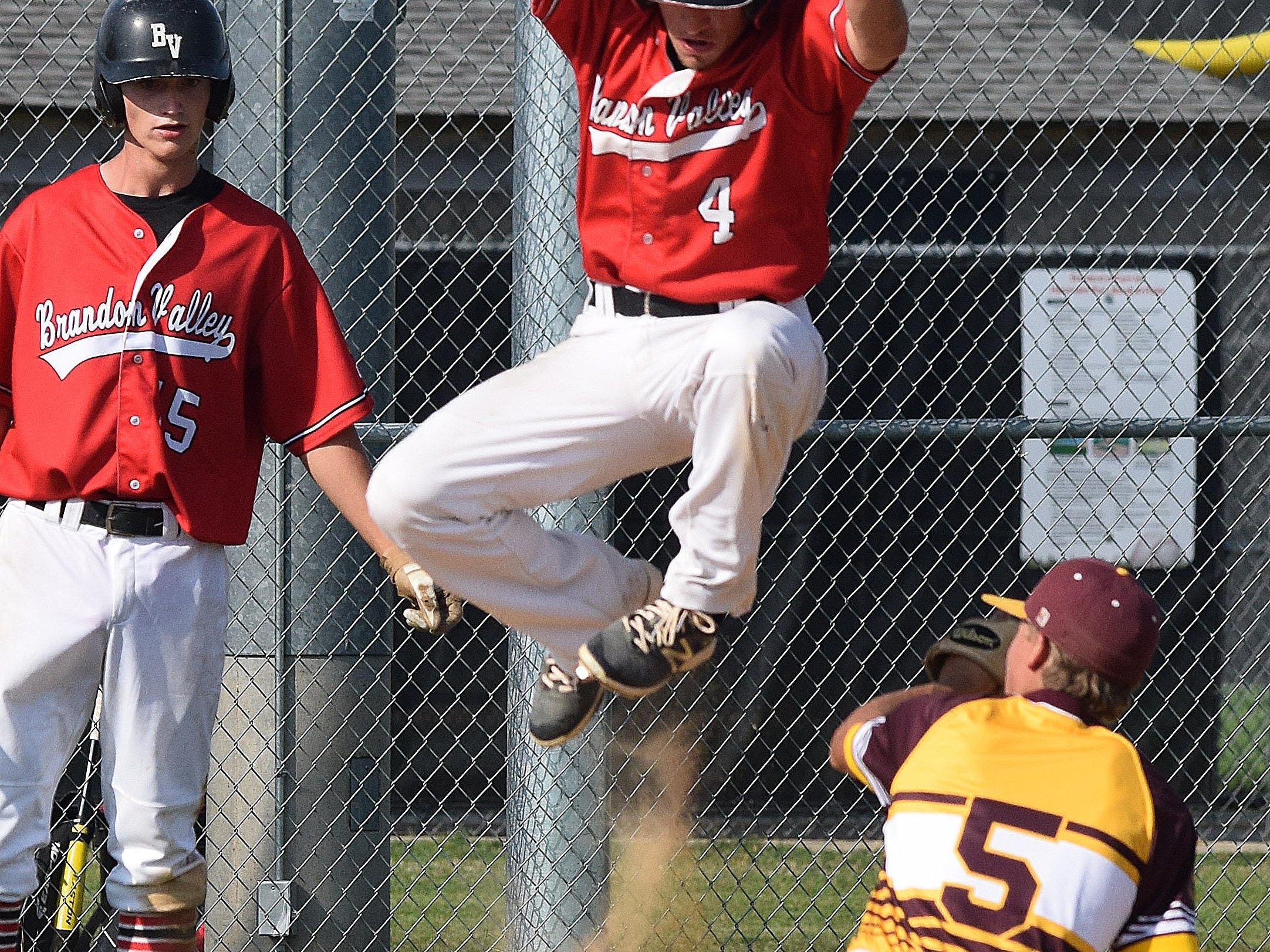 Despite being tagged out, Post 131’s Calvin Kedik elevates himself over the Harrisburg player during Brandon Valley’s 3-0 shutout in game two of the Region 2A American Legion Baseball Tournament last week.