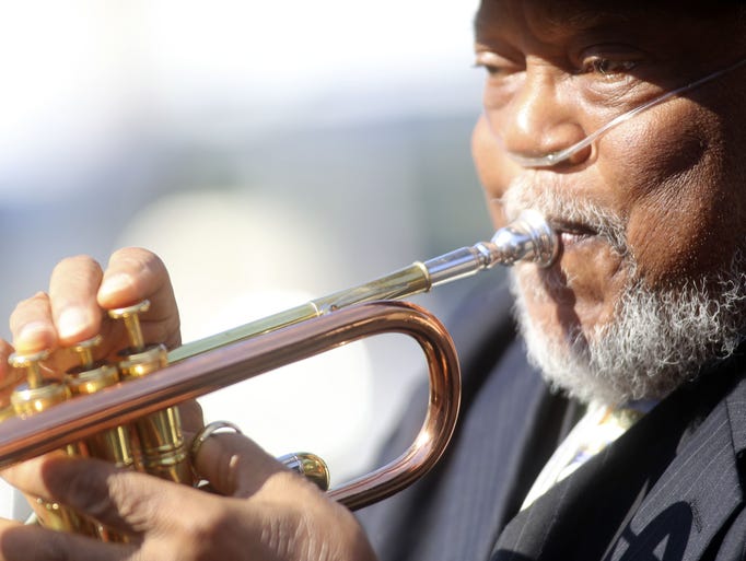 Marcus Belgrave plays the trumpet at the funeral of