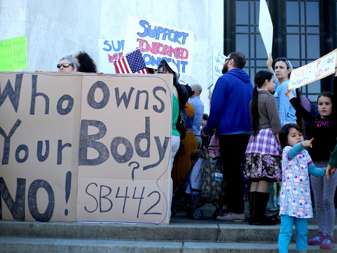 Advocates attend a "No on Senate Bill 442" rally at