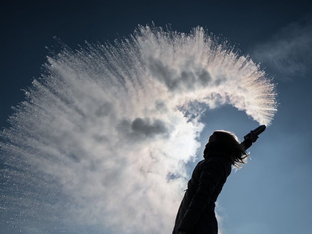 A woman tosses hot water into the freezing cold air that turns into a sparkling cloud of snow. Fresh heavy snowfalls and icy blizzards were expected to lash Europe as the region shivers in a deadly deep-freeze that has gripped countries from the far 